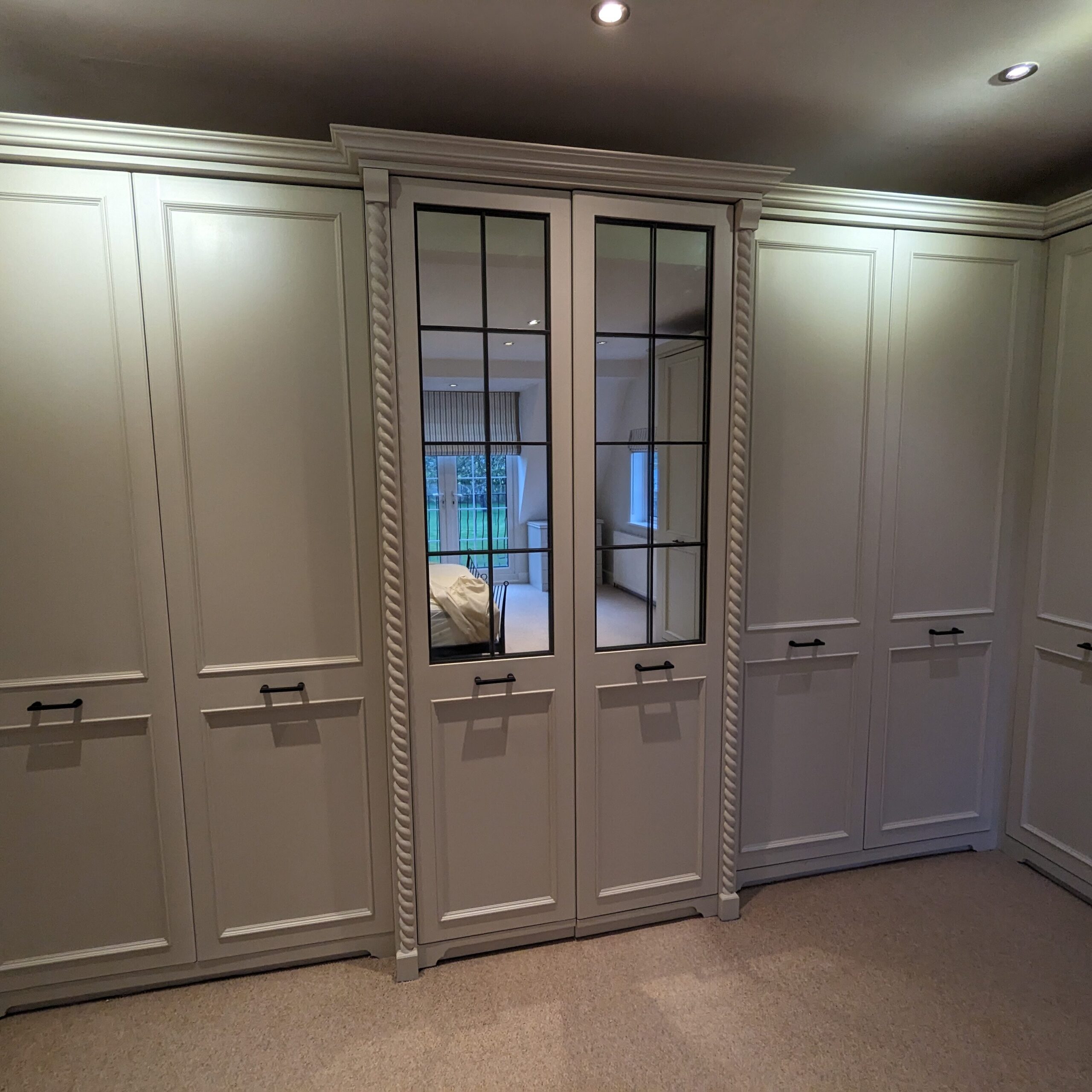 fitted wardrobes with a mirror on the door.